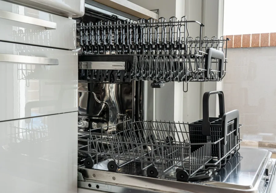 Open dishwasher loaded with clean glassware