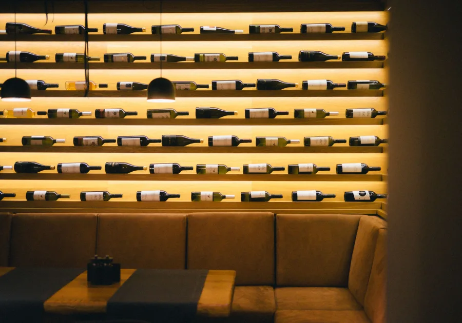 Wine cooler with bottles resting on wooden shelves